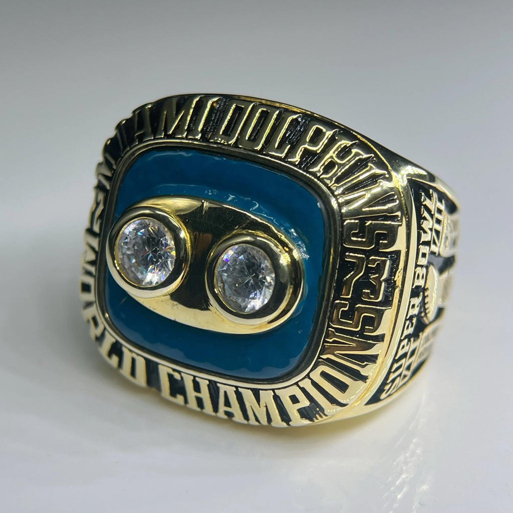 Gold championship ring with two diamonds on a white background