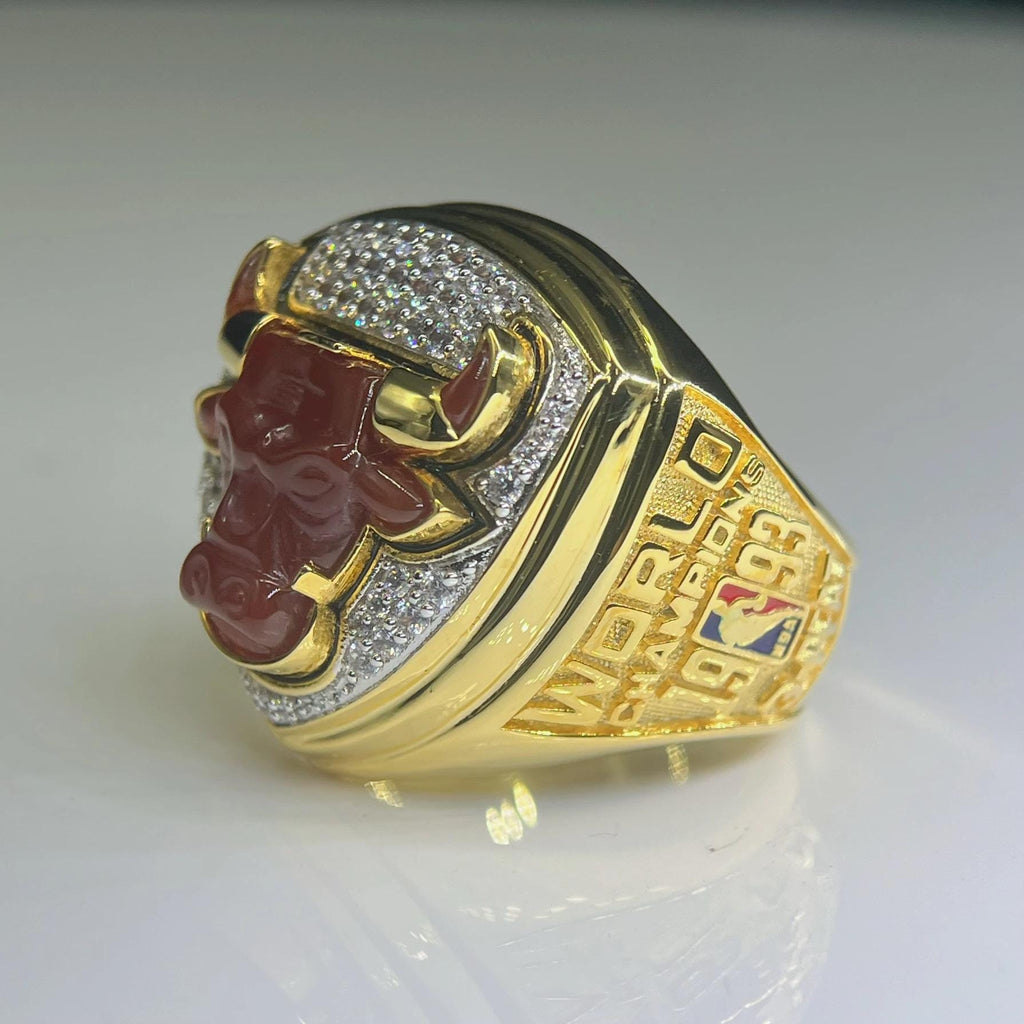Gold sports ring with red emblem and 'World Champions' text on a white background