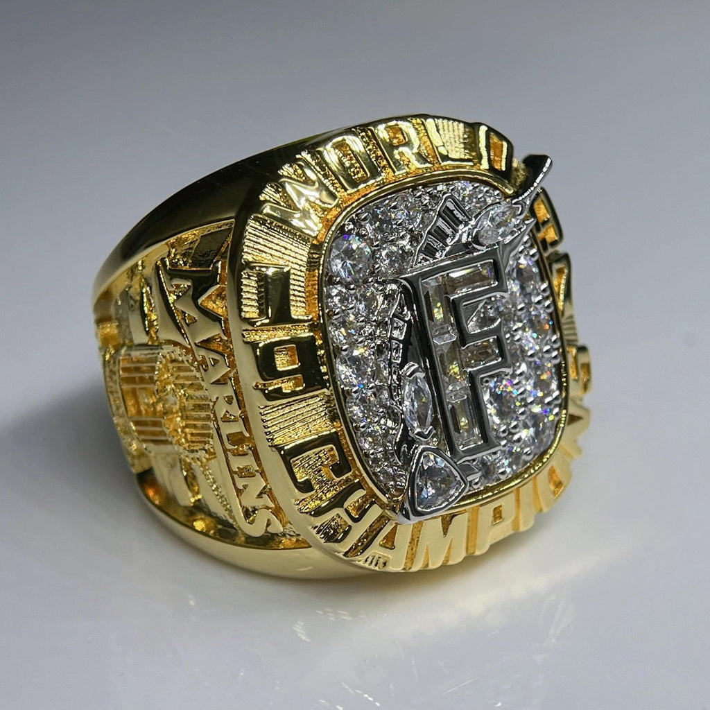 Gold ring with diamond accents on a white background