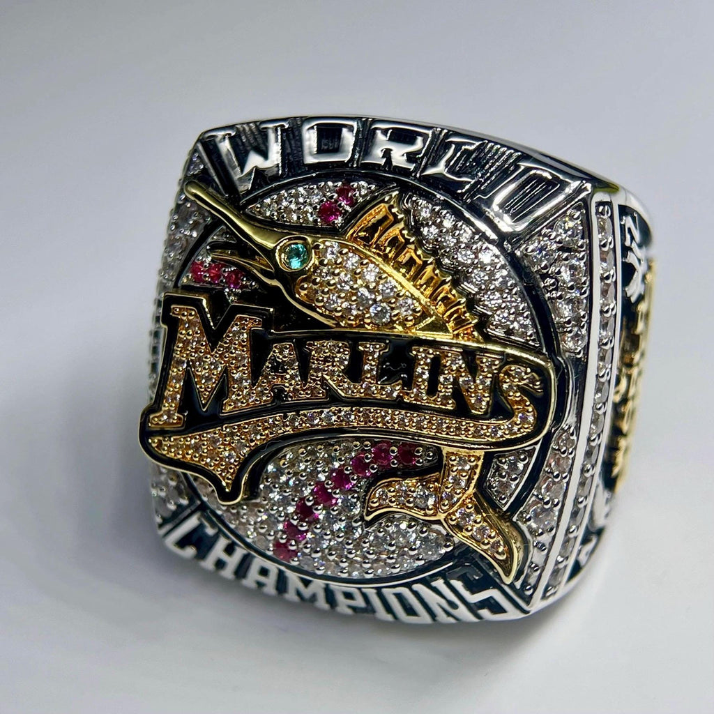 World Series championship ring with 'Miami Marlins' text on a white background
