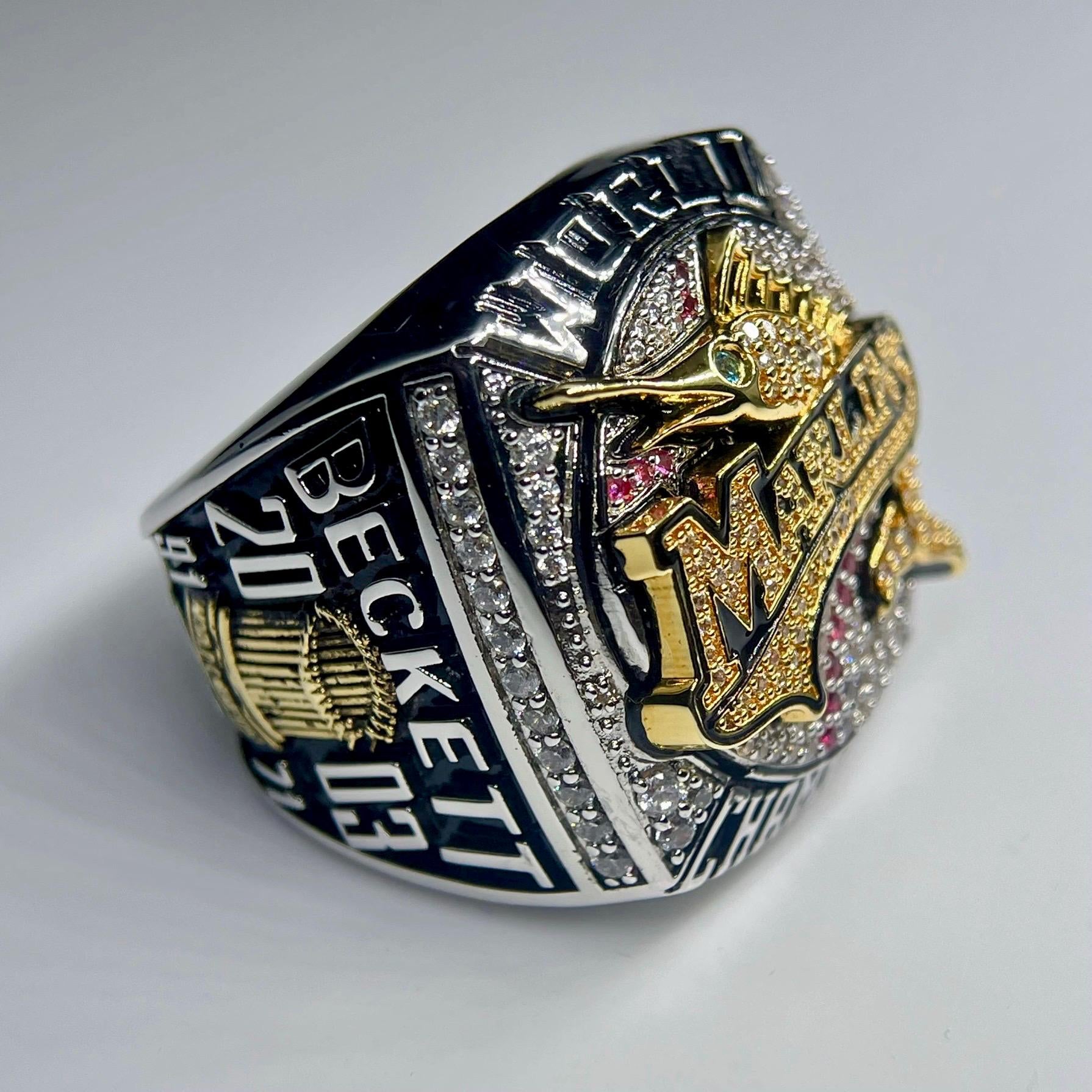 Luxury ring with prominent branding on a light gray background