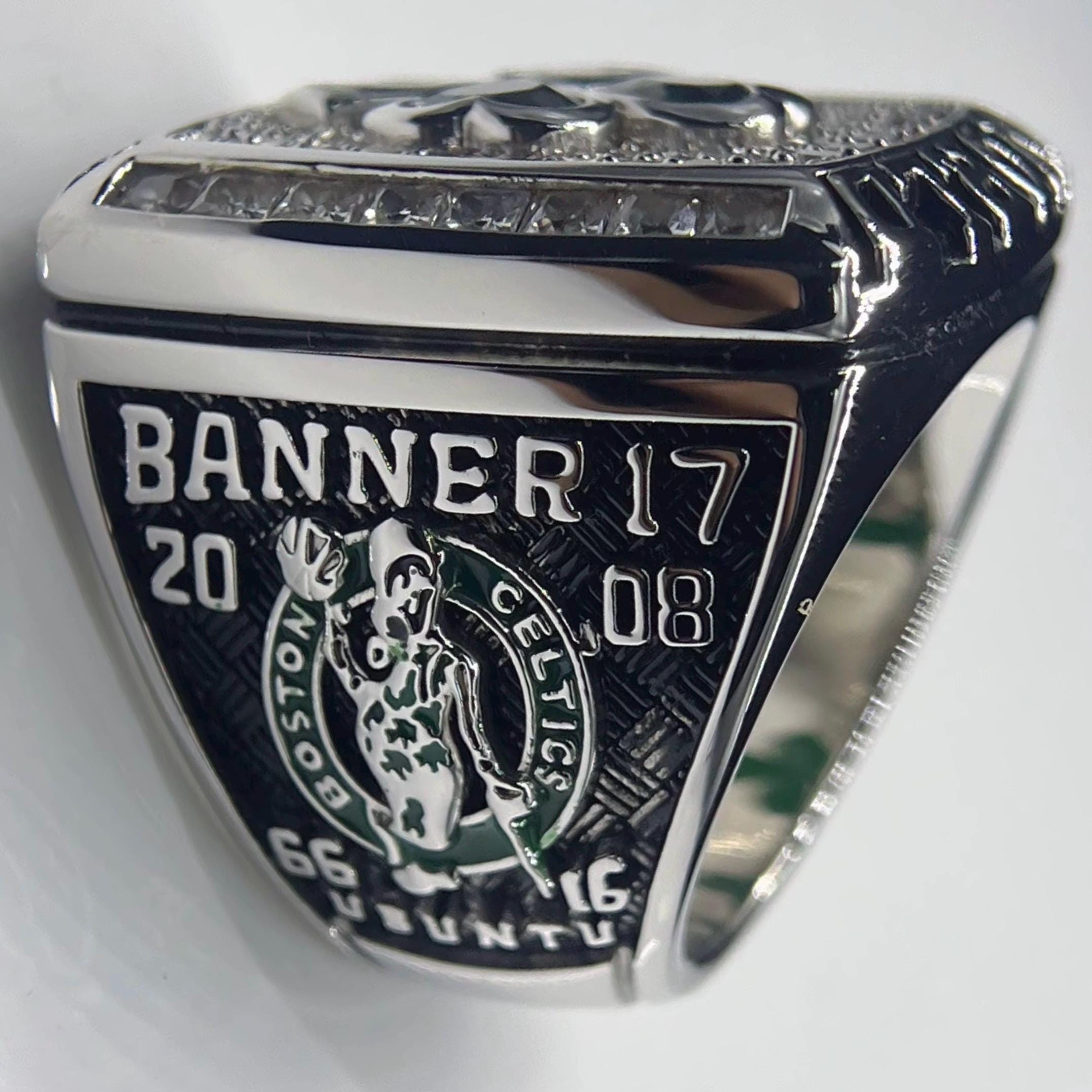 Silver ring with 'Banner 17' and '2008' engraving on a white background