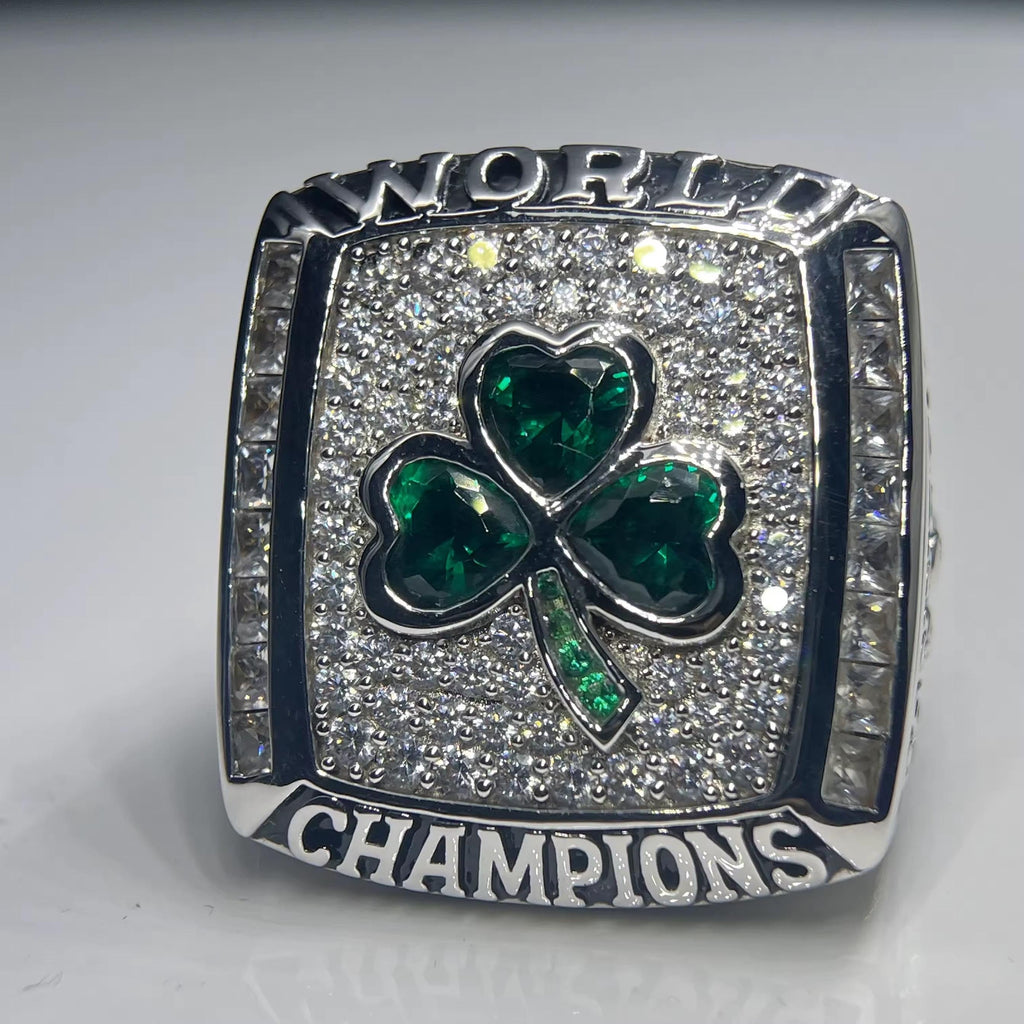 Ring with green shamrock design and 'World Champions' text on a gray background