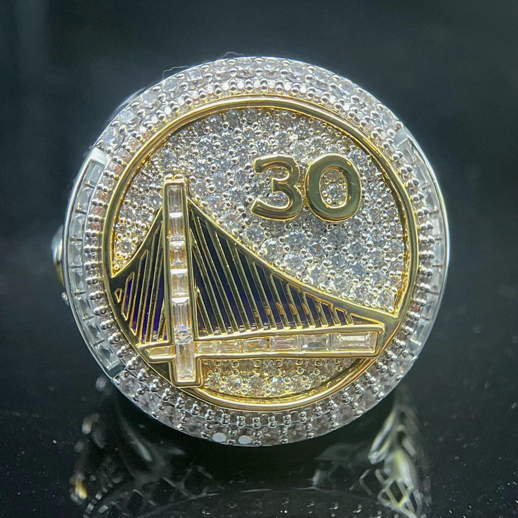 Decorative coin with '30' and a bridge design on a dark background