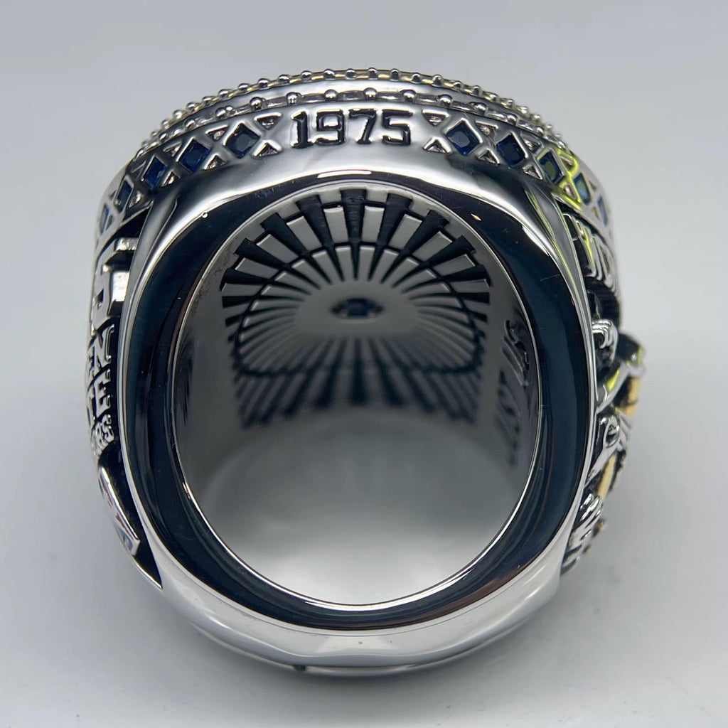 Silver ring with engraved design on a white background