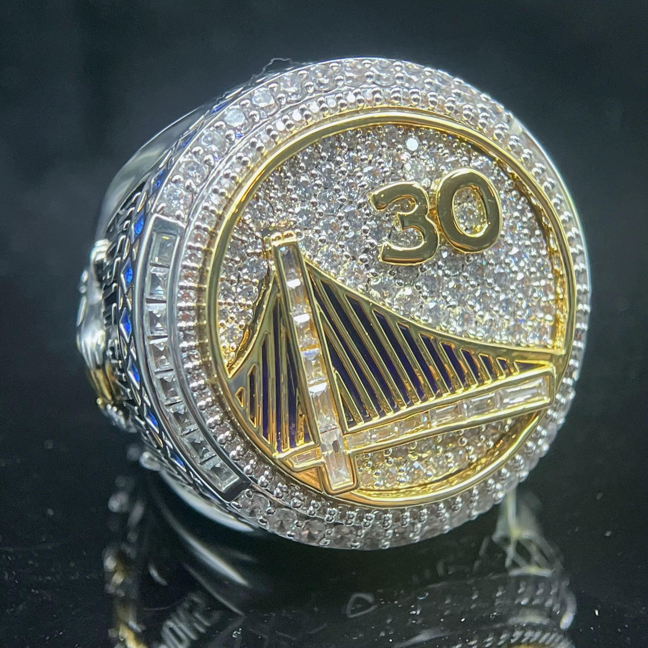 Ring with '30' and a design on a dark background