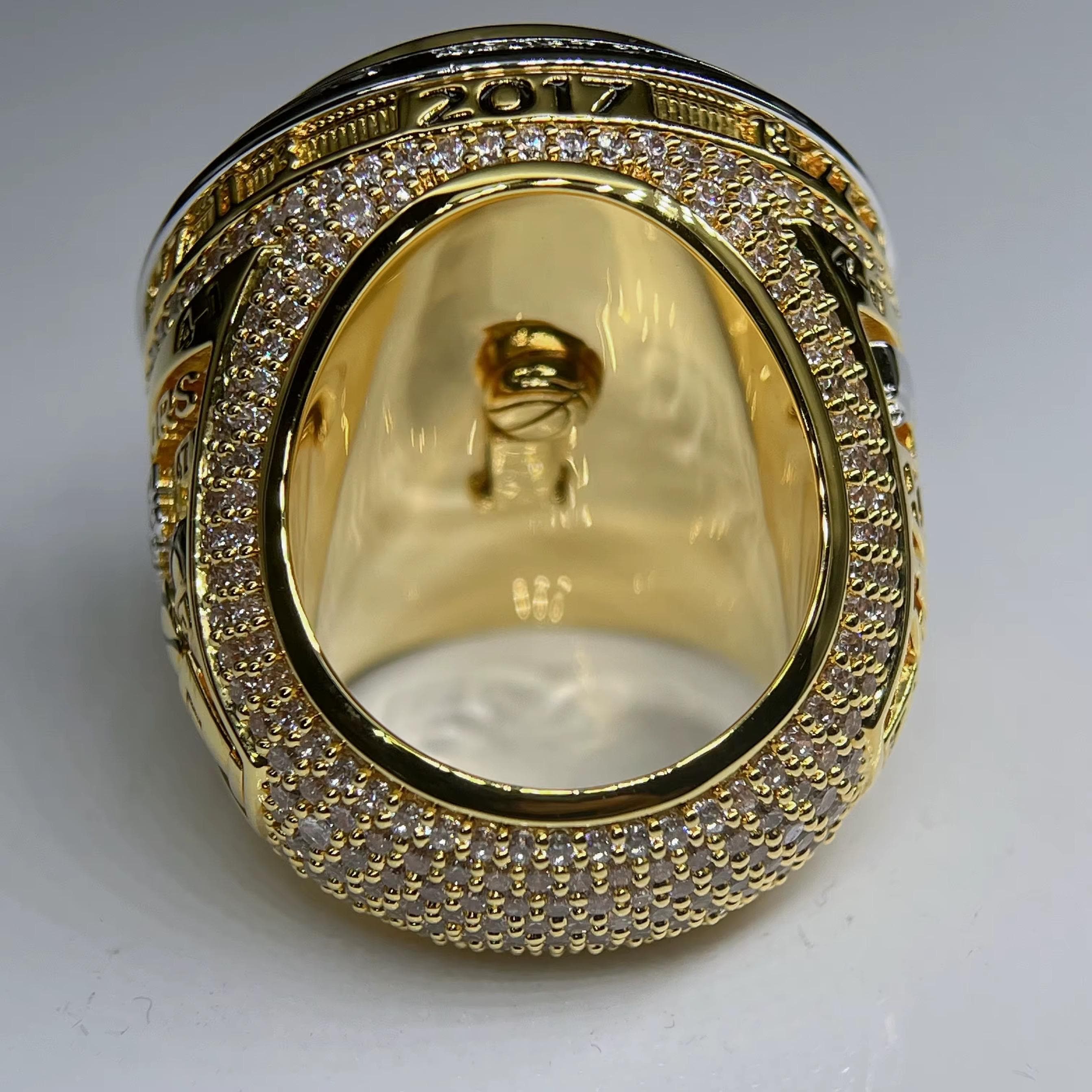 Gold ring with diamond accents on a white background