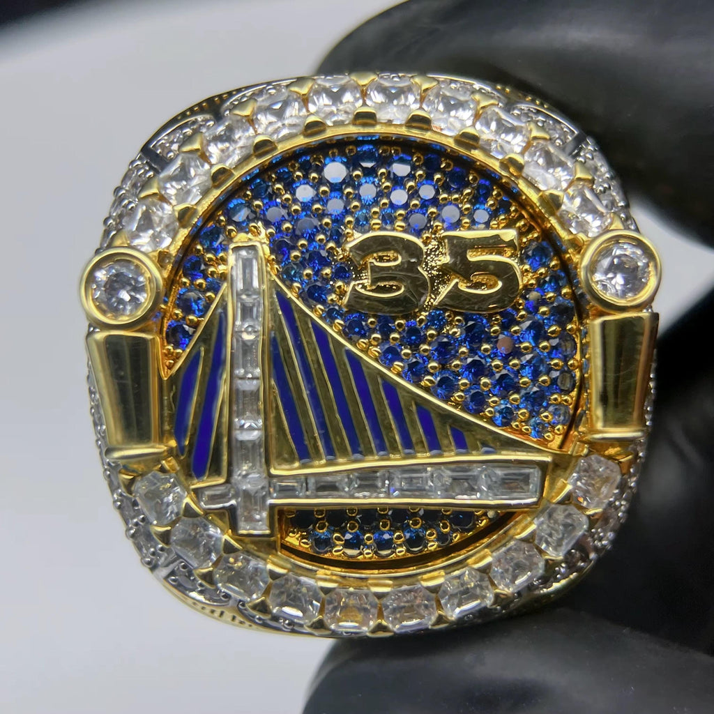 Gold and blue championship ring with number 35 on a white background
