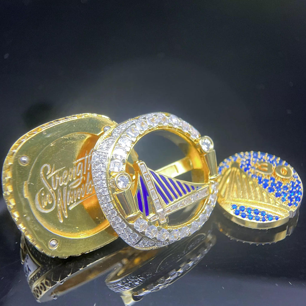 Gold and blue decorative items with intricate designs on a reflective surface