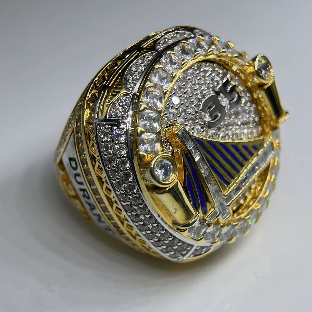 Gold and silver ring with diamond accents on a white background