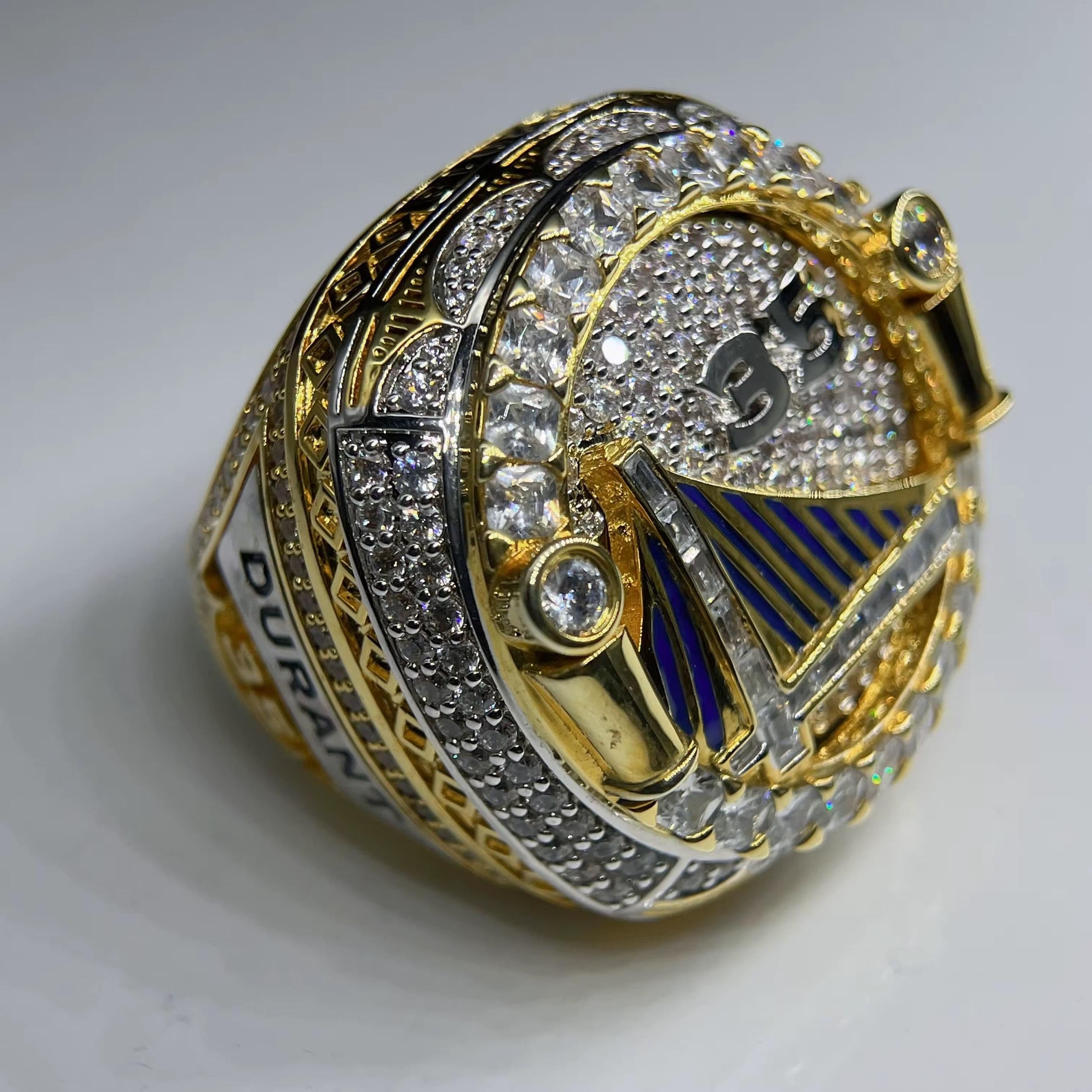 Gold and silver ring with diamond accents on a white background