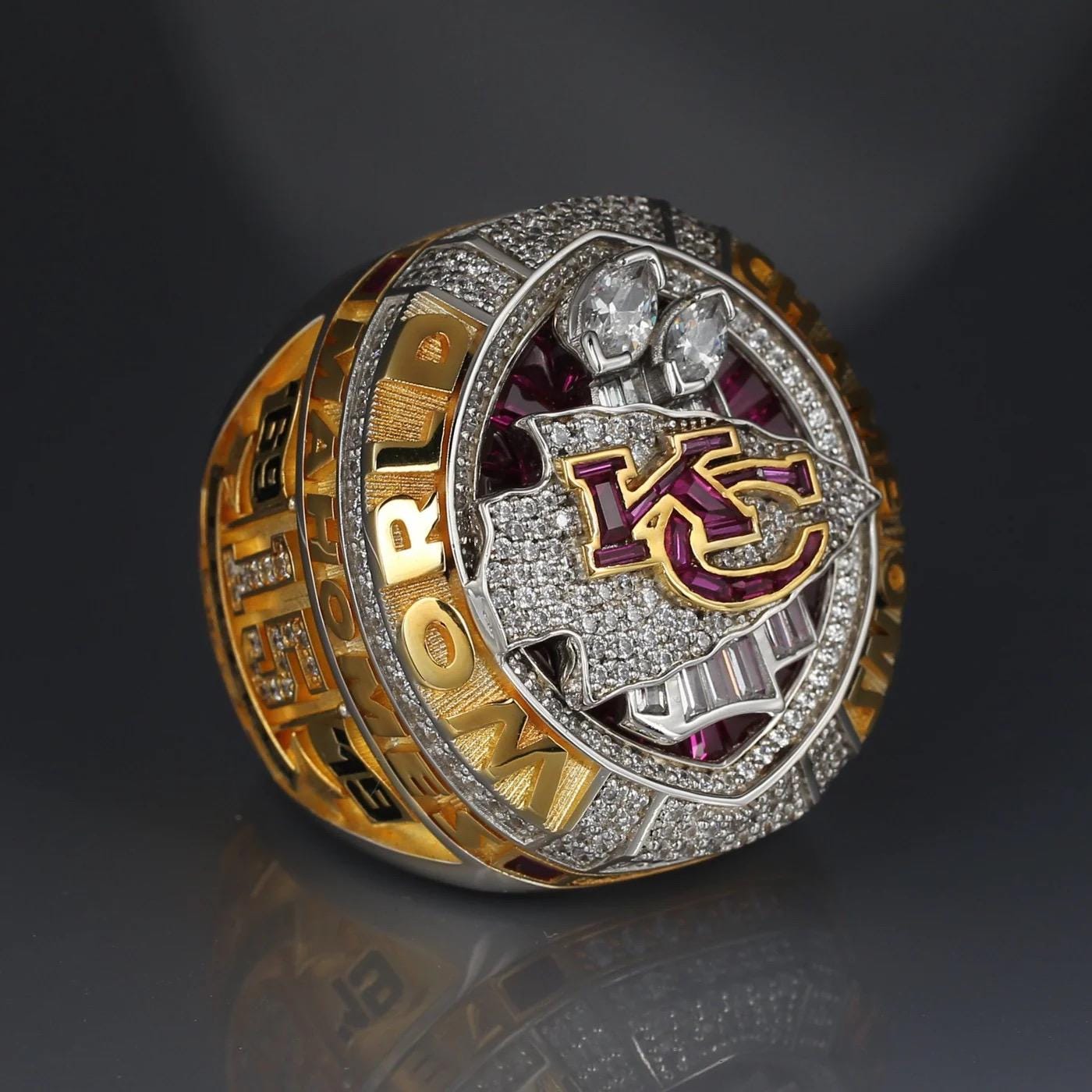 Luxury sports ring with 'KC' logo on a dark background