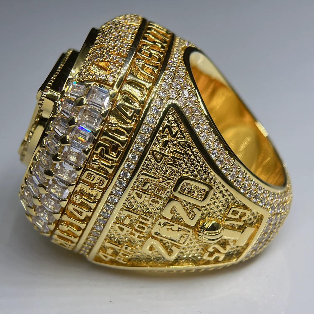 Gold ring with diamond accents on a gray background