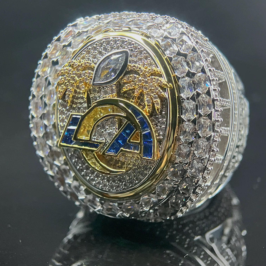 Luxury sports team logo ring with crystals on a reflective surface
