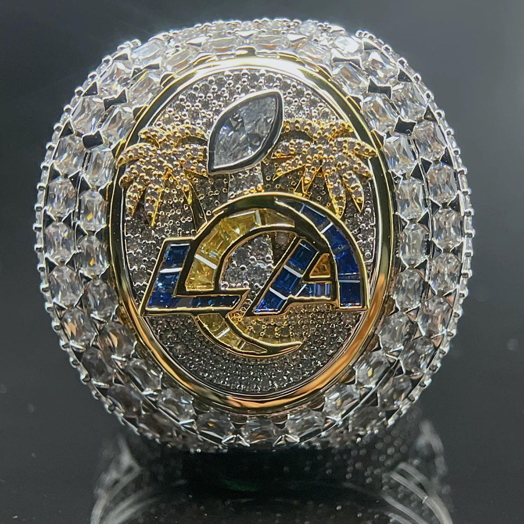 Decorative object with 'LA' logo and crystal-like embellishments on a dark background