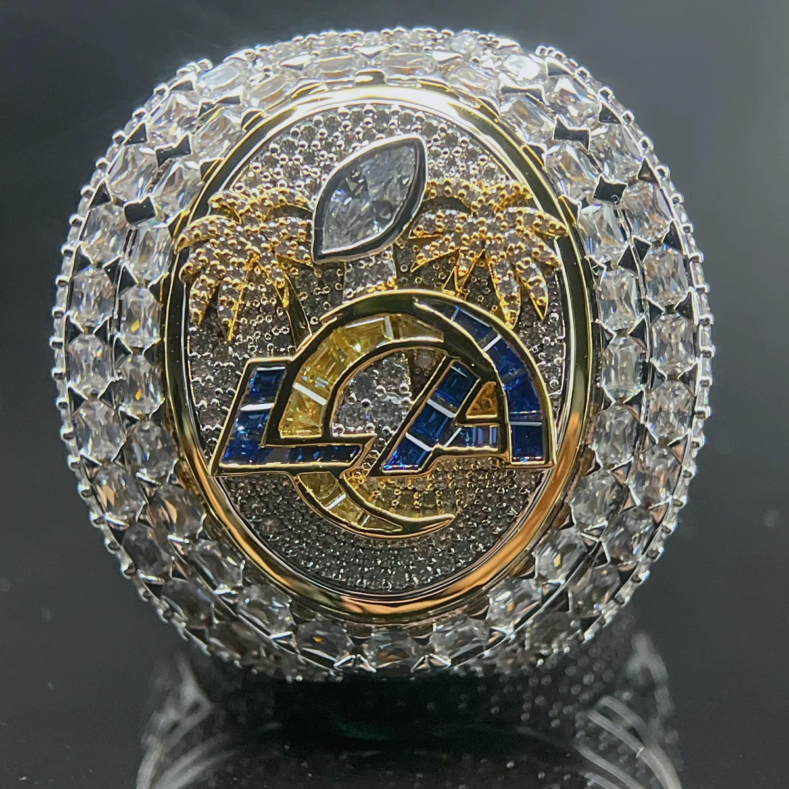 Decorative object with 'LA' logo and crystal-like embellishments on a dark background