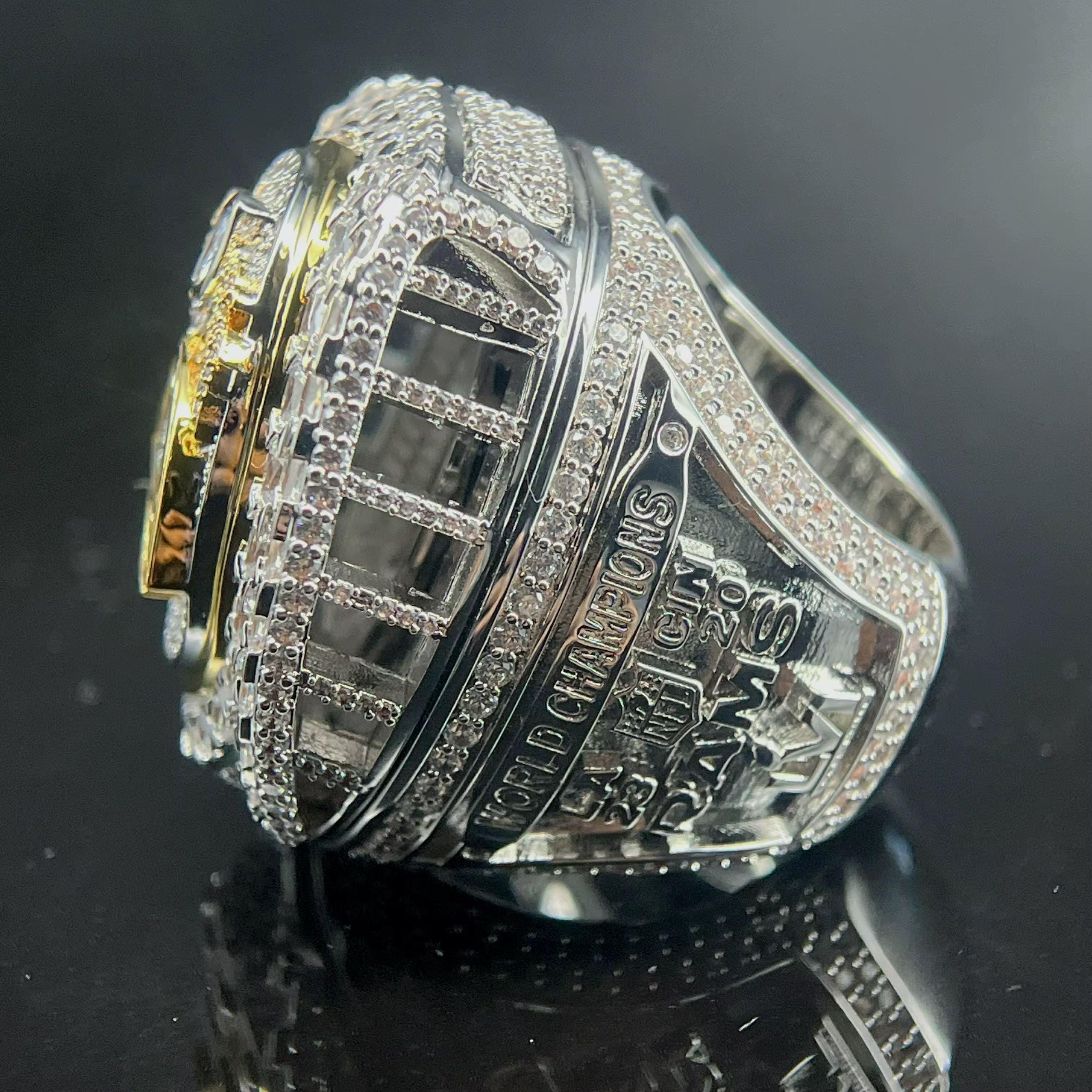 Silver championship ring with text on a black background