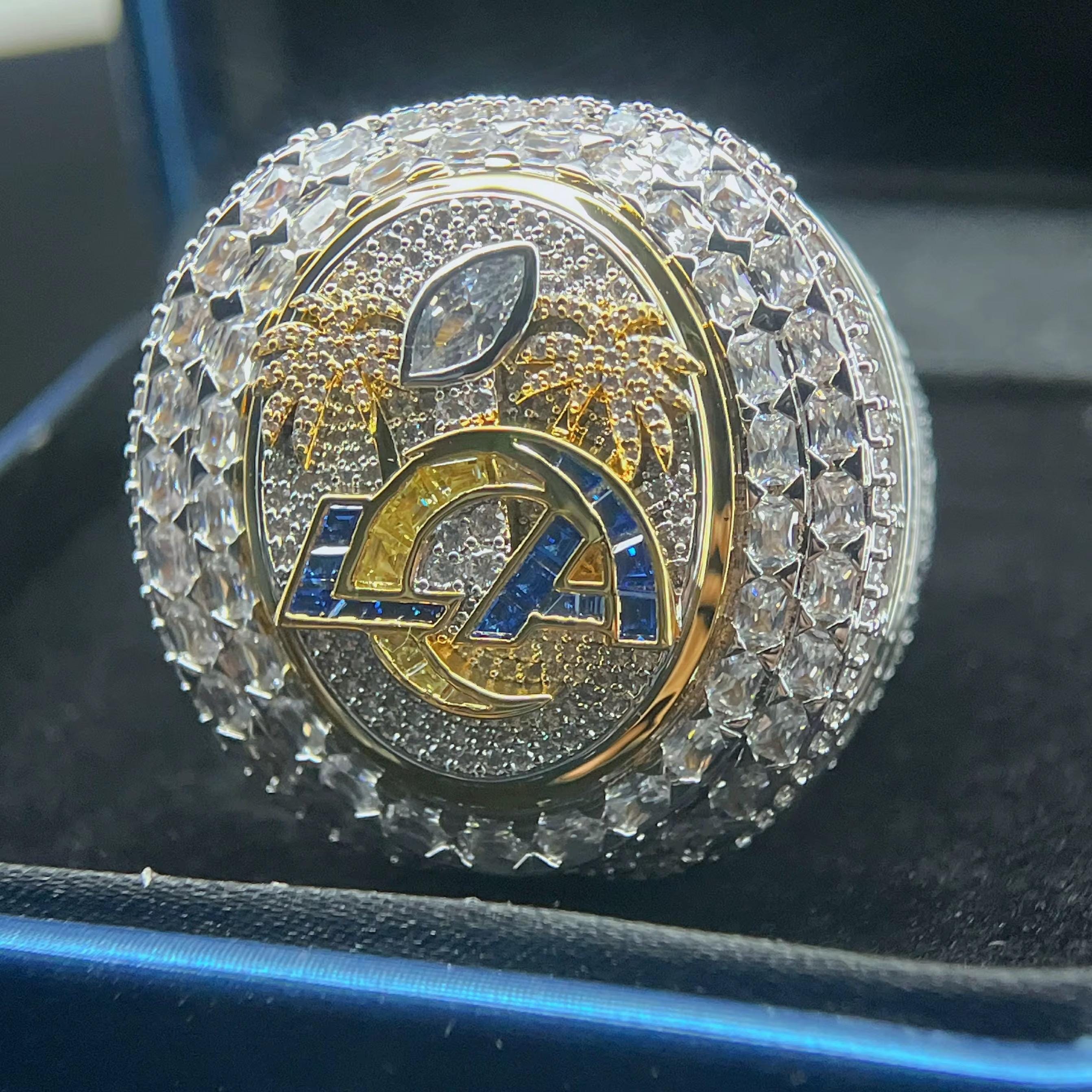 Decorative emblem with 'LA' logo on a reflective surface