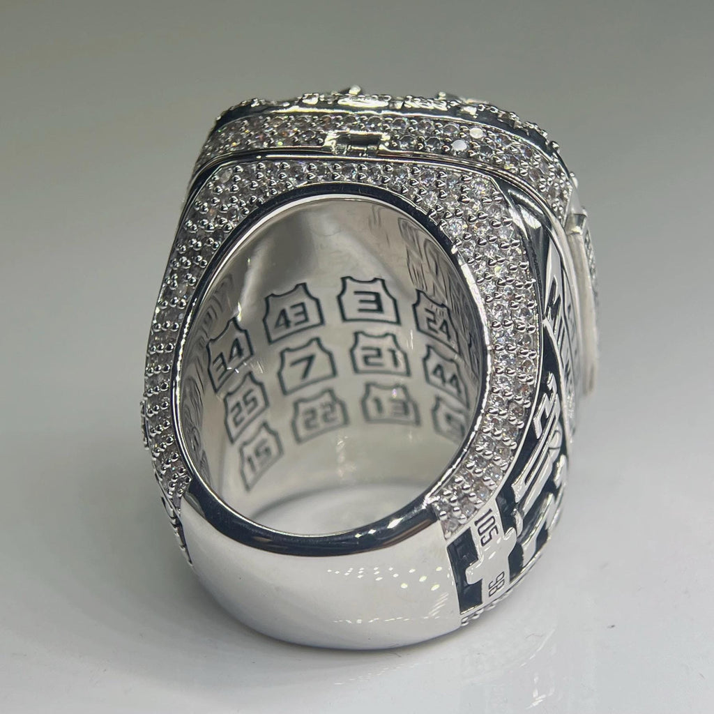 Silver ring with engraved text on a gray background