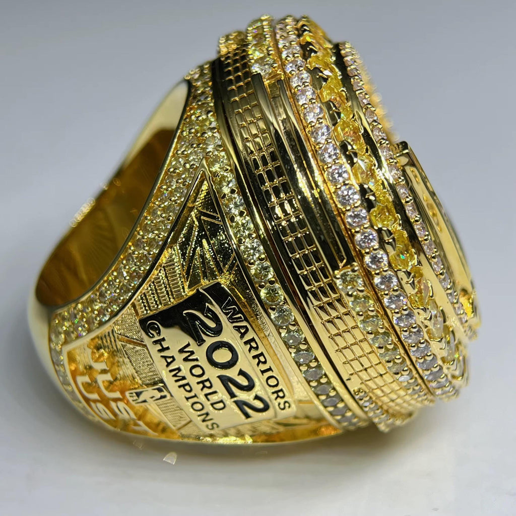 Gold championship ring with '2022 World Champions' text on a gray background