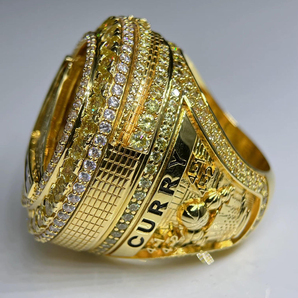 Gold ring with 'CURRY' engraving on a gray background