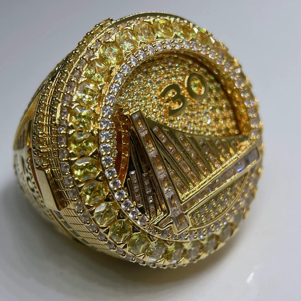 Gold ring with diamond accents and number '30' on a white background