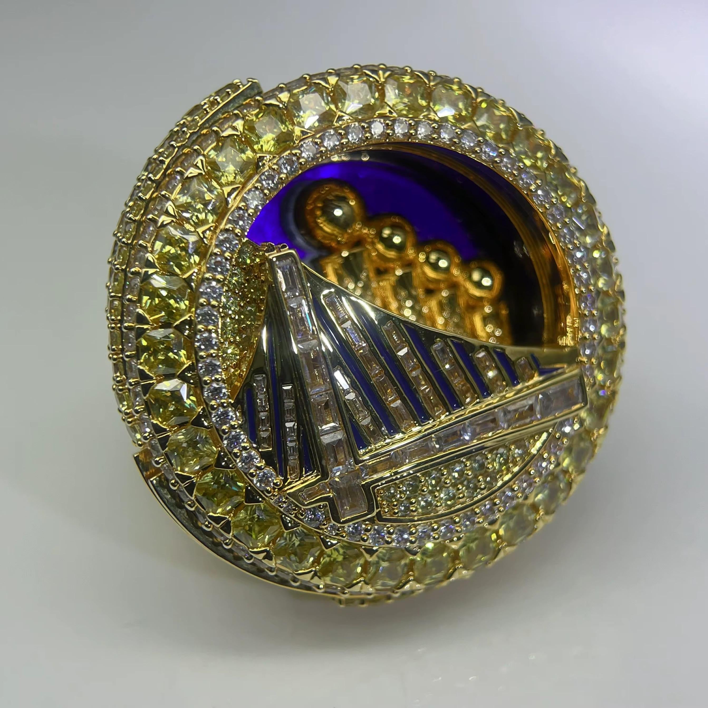 Gold and diamond-encrusted brooch with a bridge design on a white background