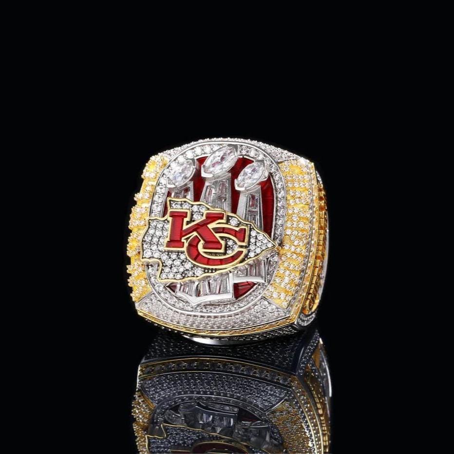 Championship ring with 'KC' logo on a black background