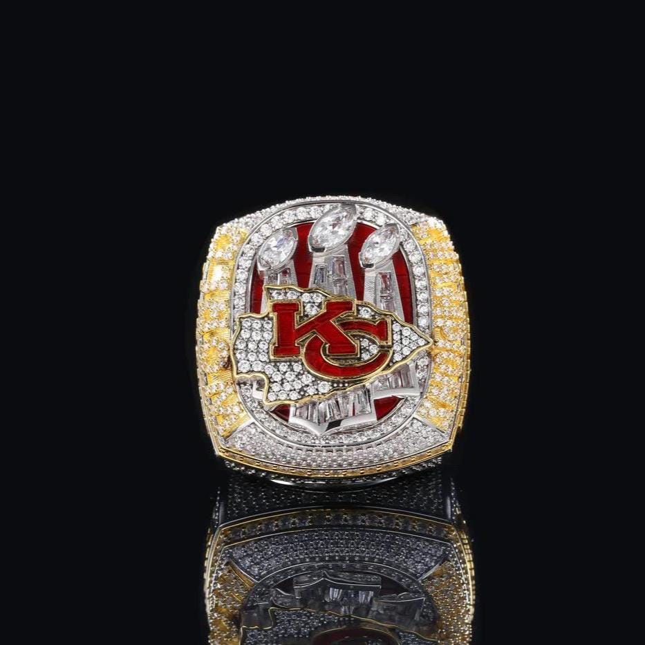 Championship ring with 'KC' logo on a black background