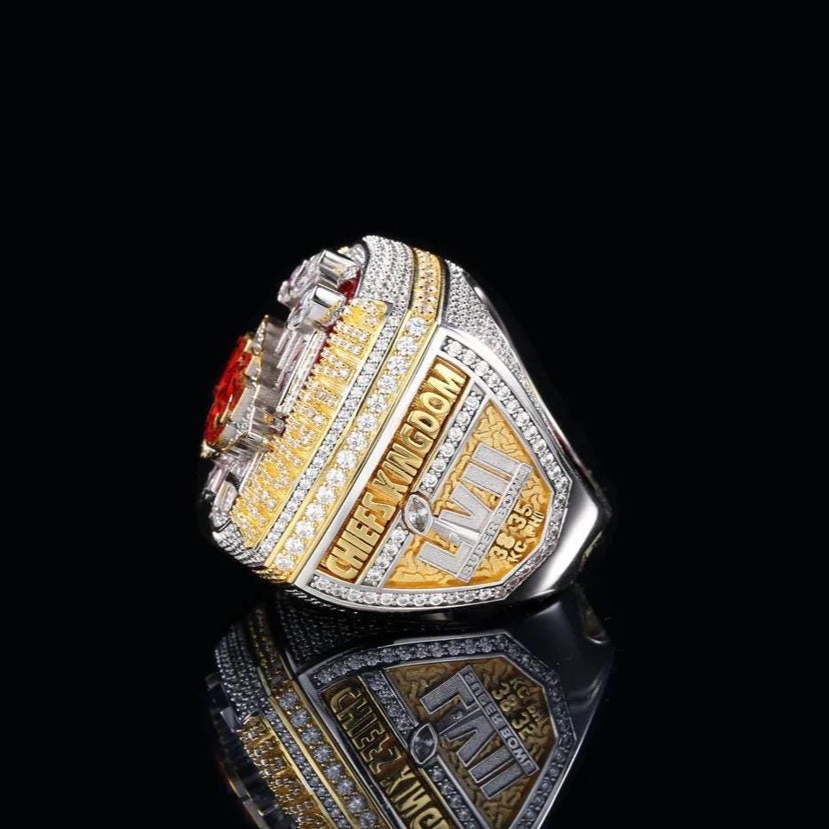 Luxury sports championship ring with gold and silver design on a black background