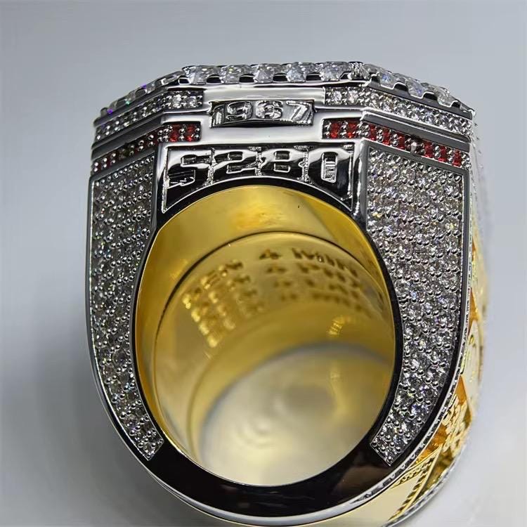 Luxury ring with diamond and gemstone accents on a gray background