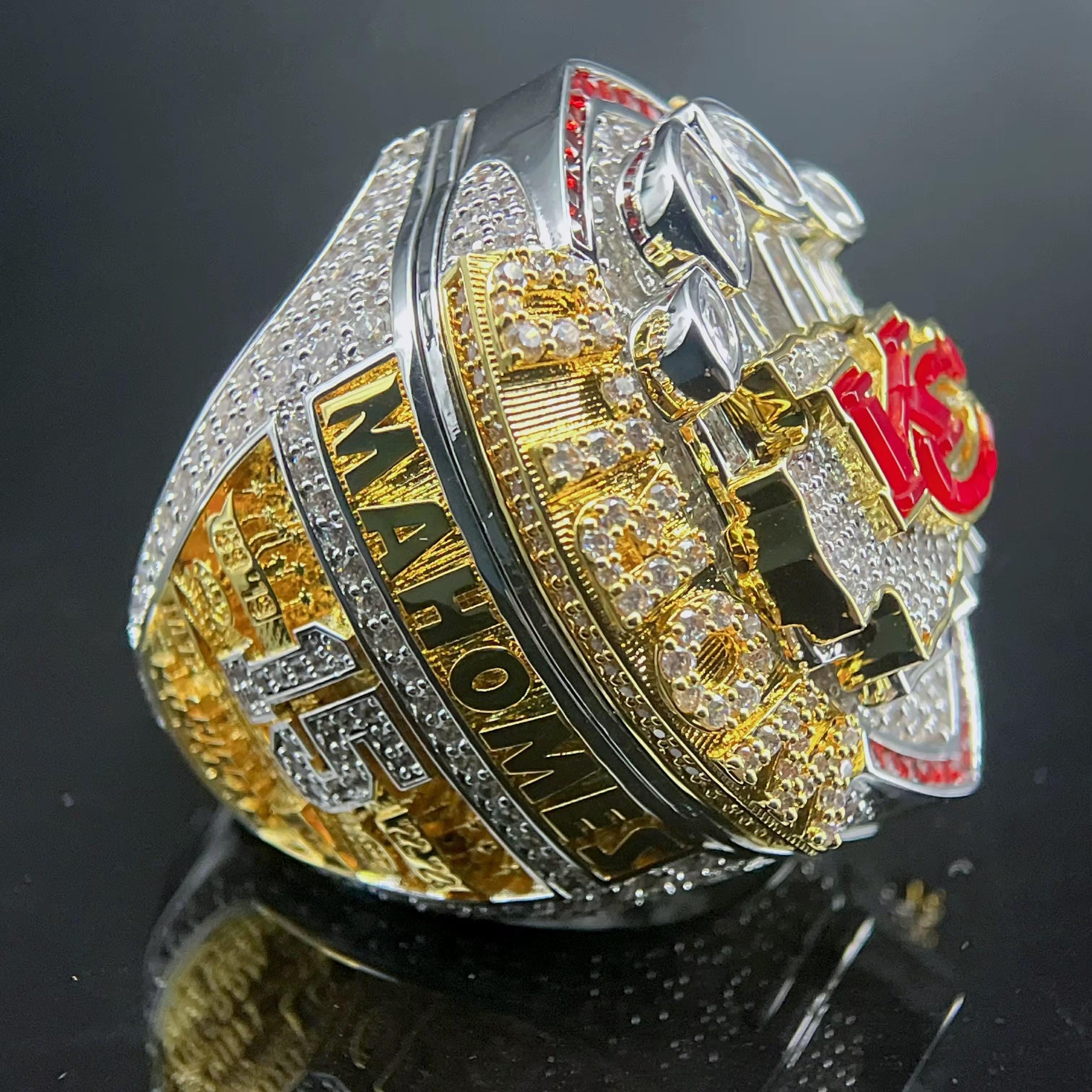Gold and silver championship ring with 'MAHOMES' text on a black background