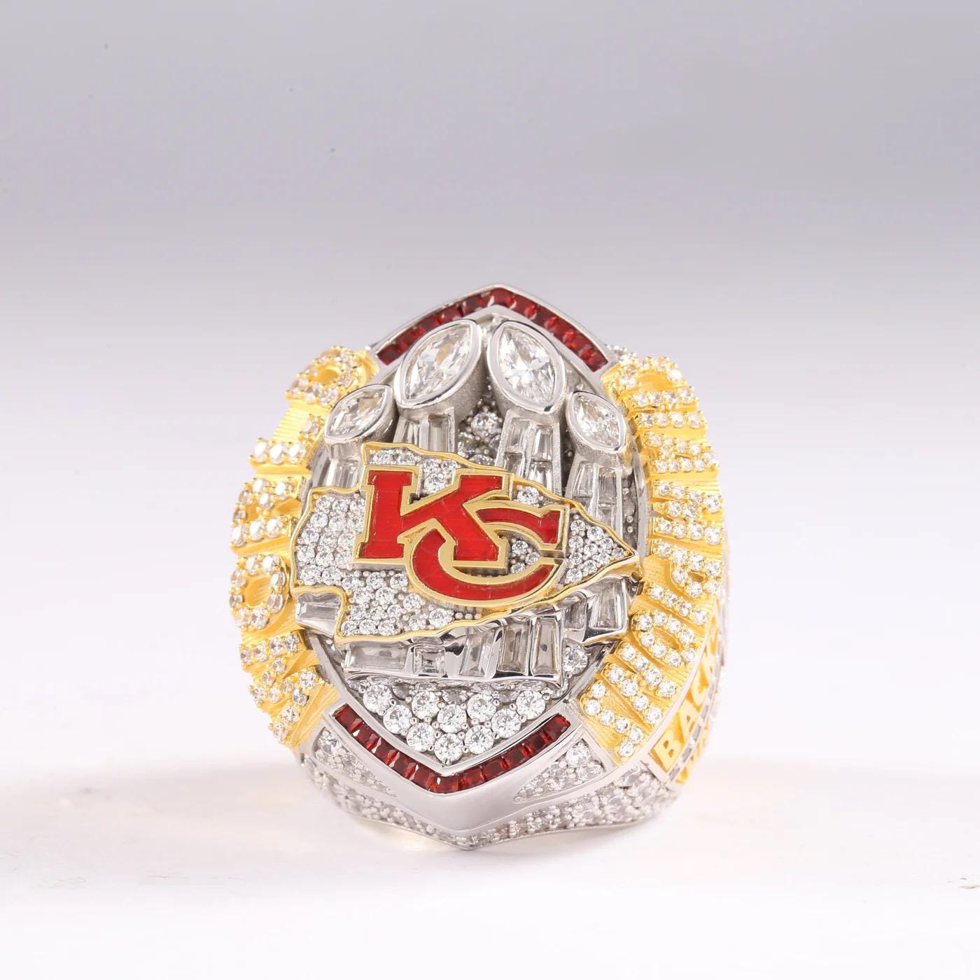 Decorative ring with 'KC' logo on a white background
