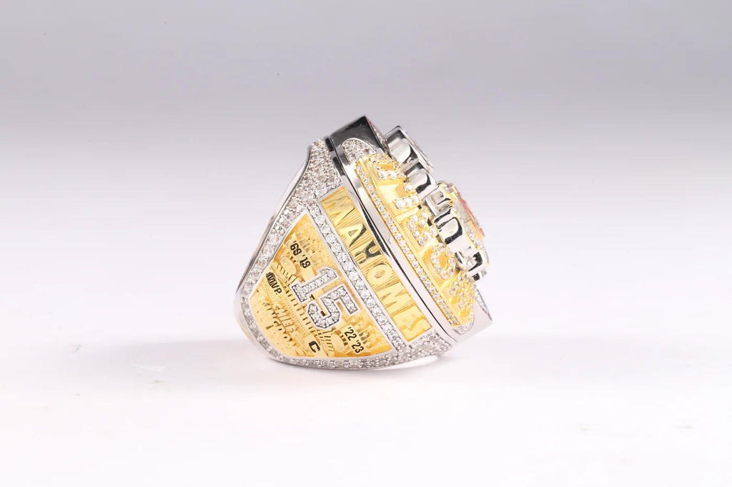 Gold and silver championship ring on a white background