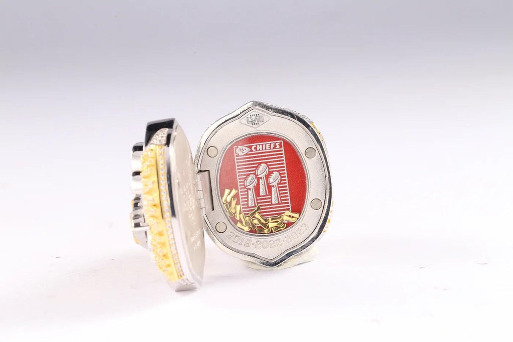 Metallic badge with red emblem on a white background