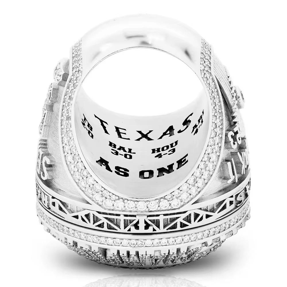 Silver ring with engraved text on a white background
