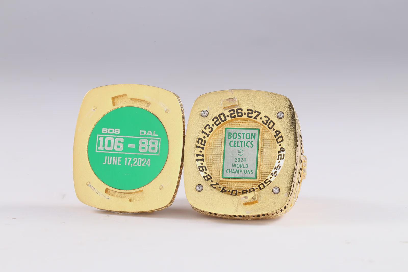 Gold championship ring with engraved text on a white background