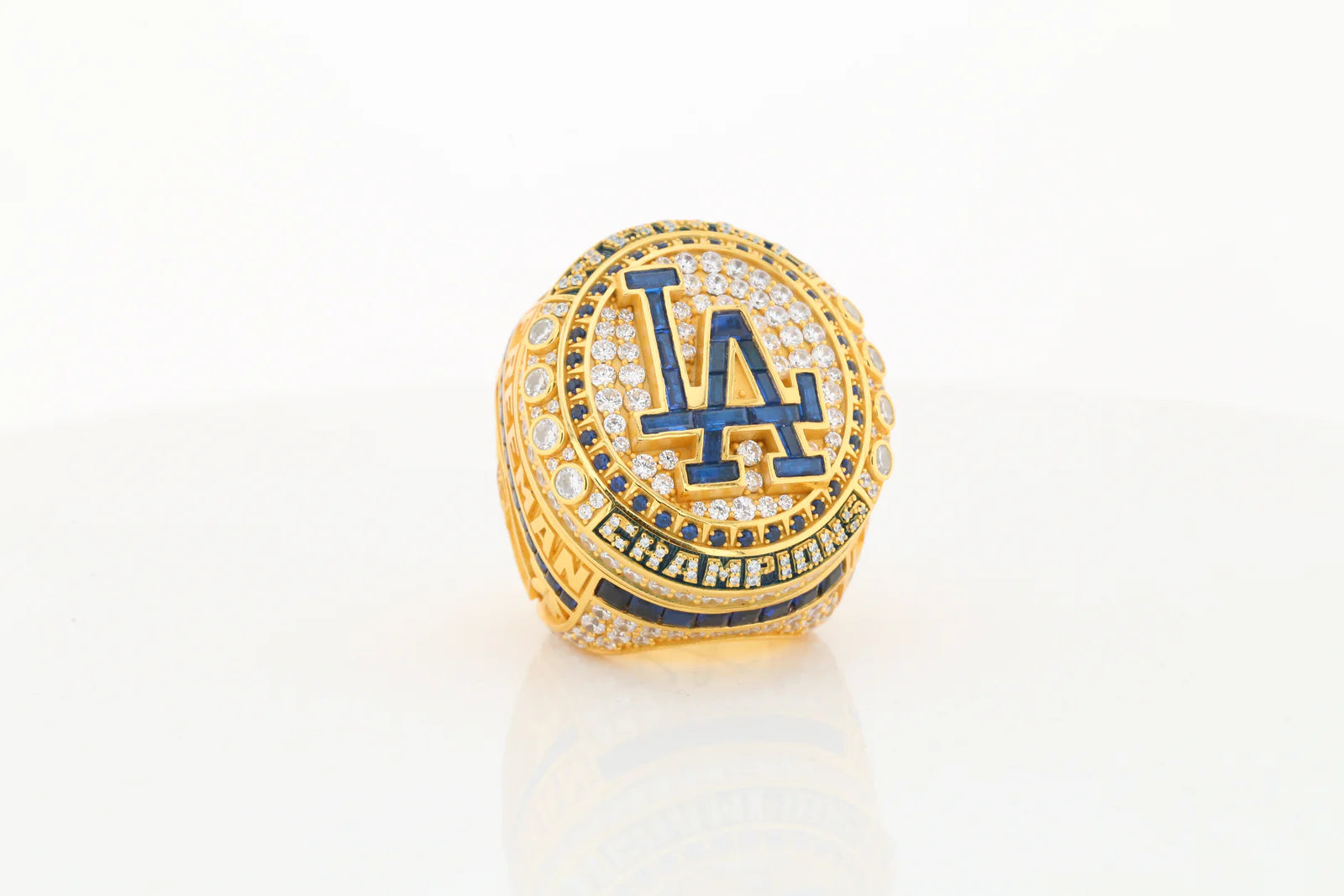 Gold championship ring with LA Dodgers logo on a white background