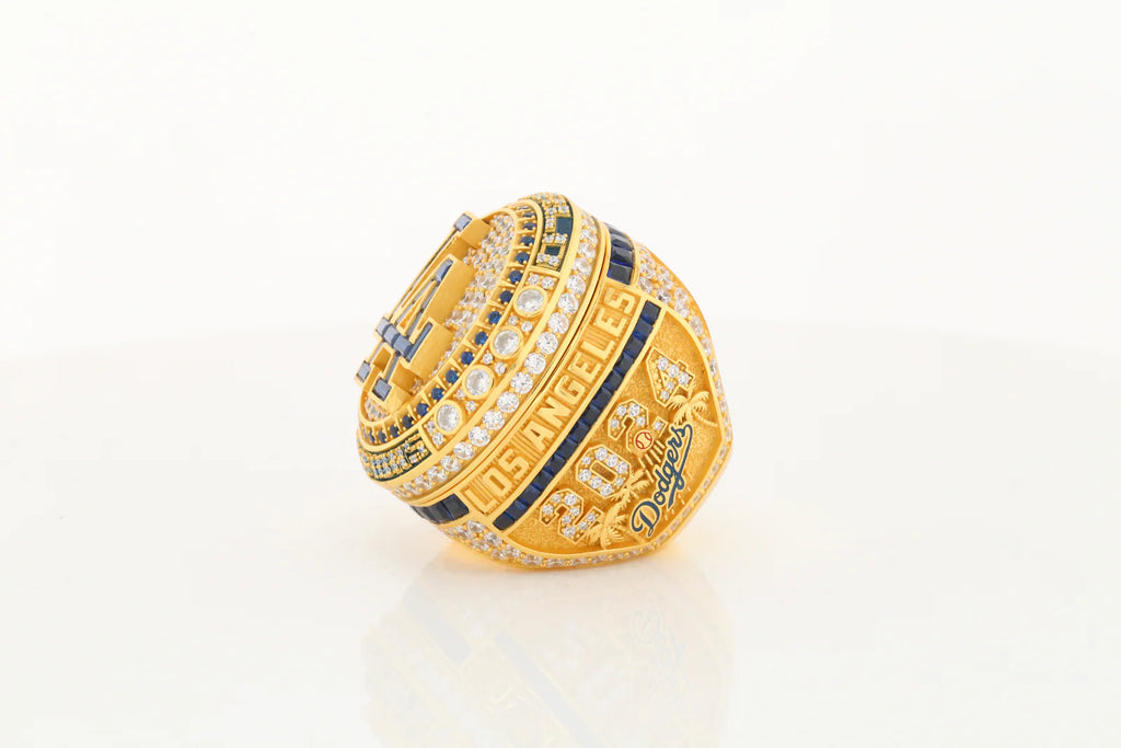 Gold championship ring with blue accents on a white background