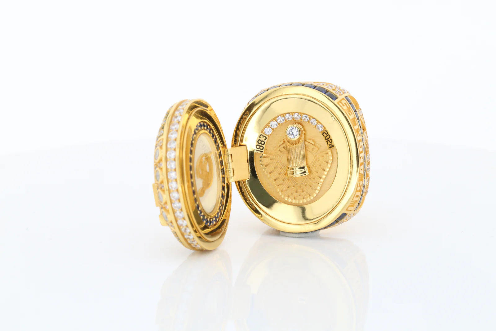 Gold lockets with intricate designs on a white background