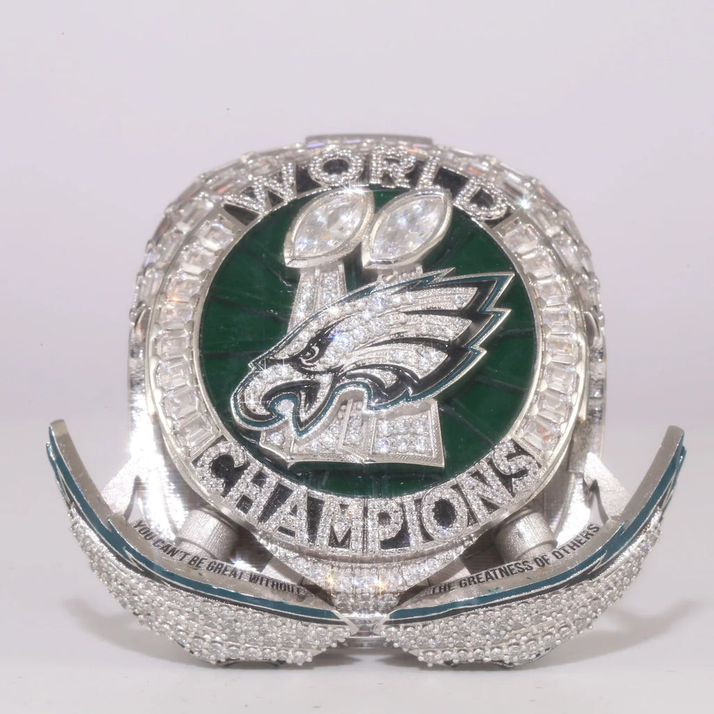Championship ring with Eagles logo and 'Champions' text on a white background