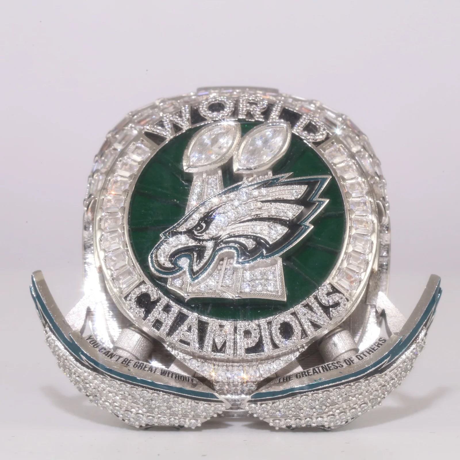 Championship ring with Eagles logo and 'Champions' text on a white background