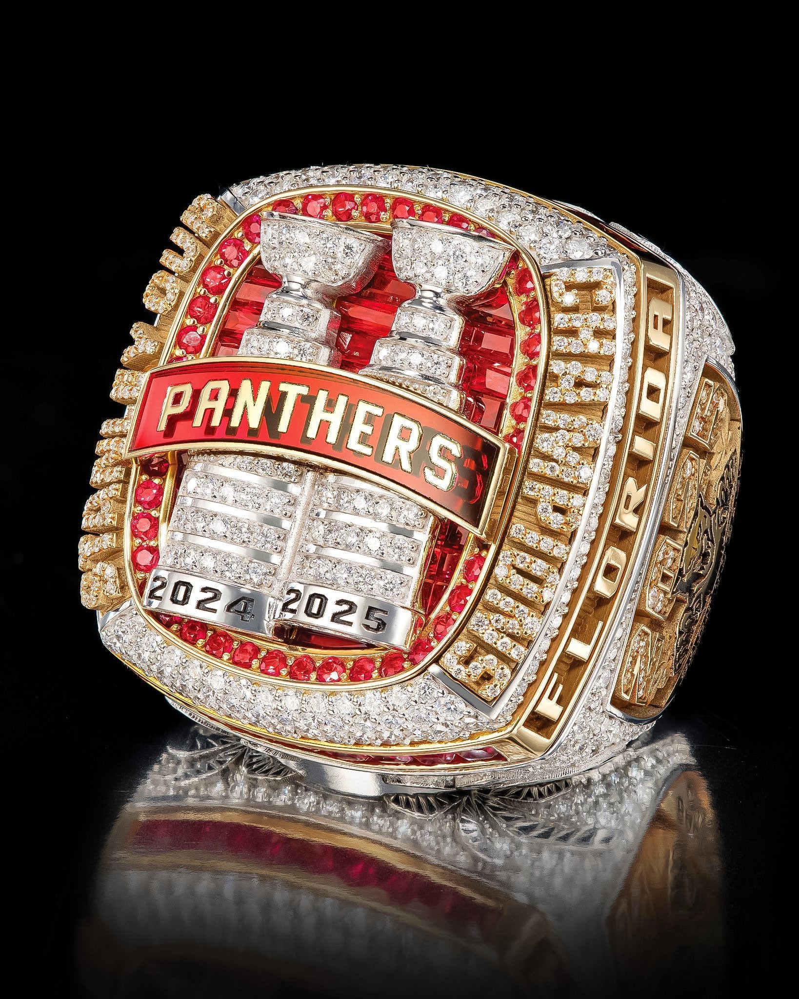 Florida Panthers championship ring with red and gold details on a black background