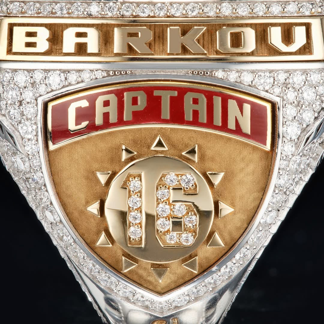 Gold and silver emblem with 'Barkov Captain 16' text on a black background