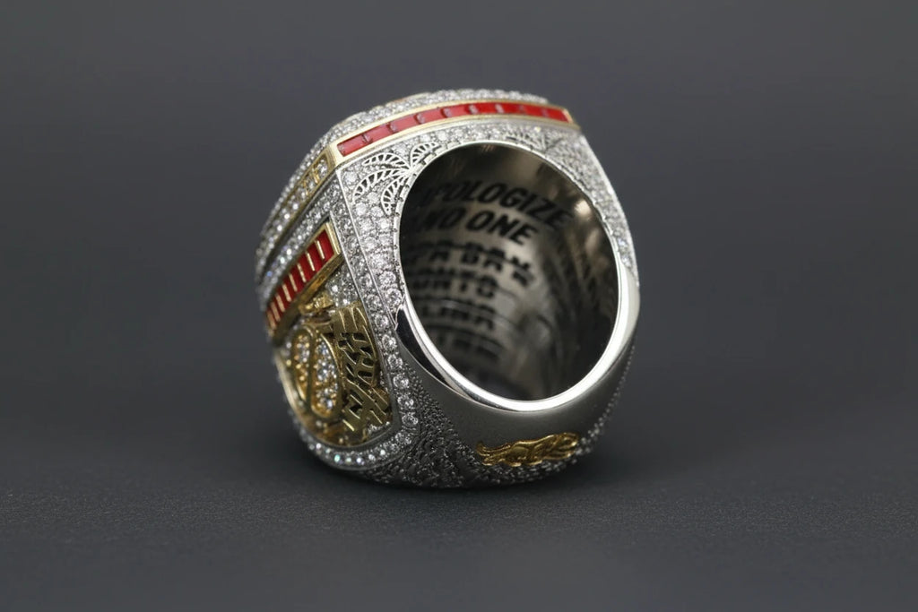 Silver ring with intricate design on a dark gray background